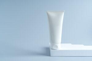 a white tube of cream standing on a white podium 2023 04 28 22 33 29 utc